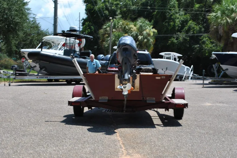 Slide: The Image of Trailer with boat engine parked, surrounded by various boats, Custom Underwood 2014 model. - 3
