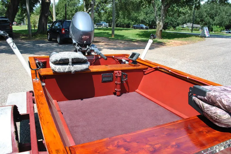 Slide: The Image of Custom 2014 Underwood boat with motor, parked outdoors on a sunny day. - 6