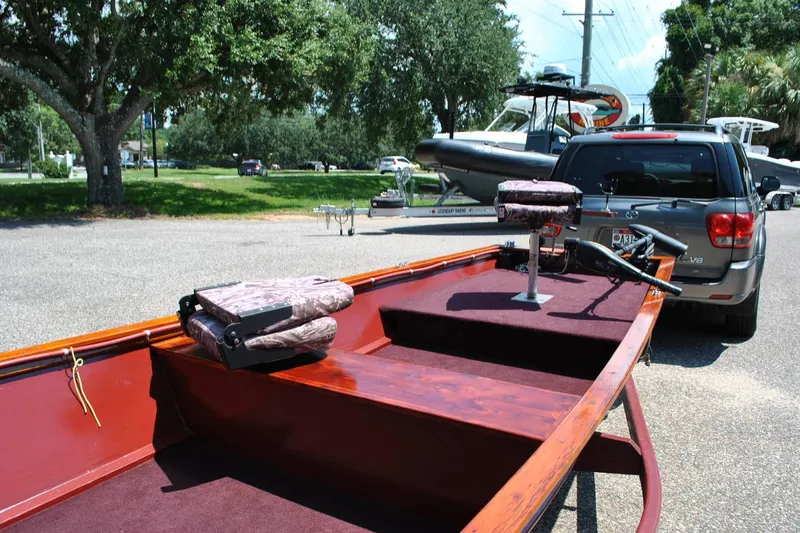 Slide: The Image of Custom 2014 Underwood boat on trailer, parked near SUV in sunny outdoor setting. - 8