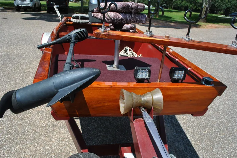 Slide: The Image of Custom 2014 Underwood boat with motor, rod holders, and LED lights on a trailer. - 9