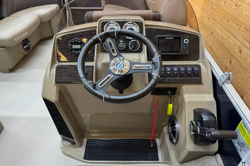 Slide: The Image of 2024 Sylvan Party Fish 820 boat dashboard with steering wheel and control panel. - 10