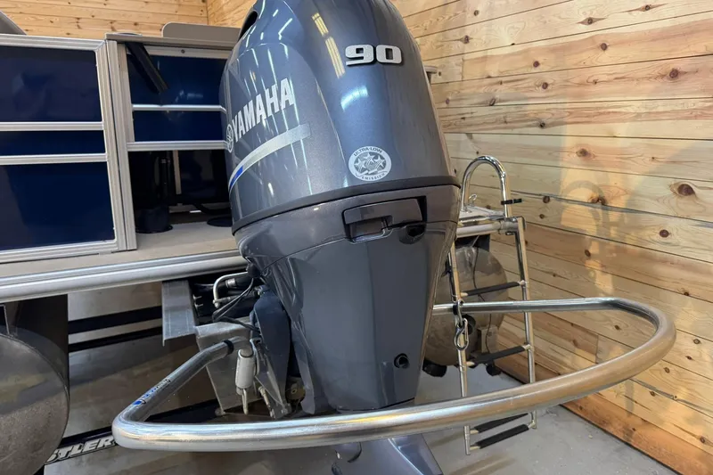 Slide: The Image of 2024 Sylvan Party Fish 820 with Yamaha 90 outboard motor in wooden garage. - 4