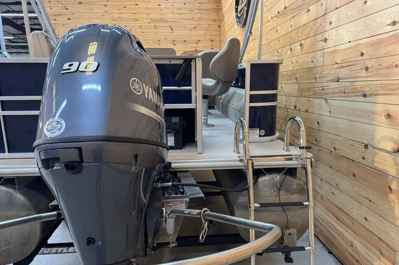 Slide: The Image of 2024 Sylvan Party Fish 820 boat with Yamaha 90 engine in wooden interior setting. - 5