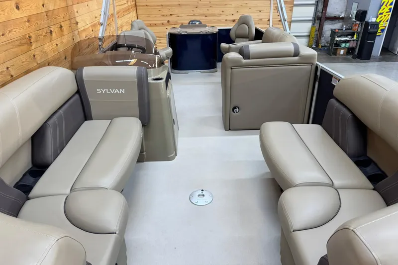 Slide: The Image of 2024 Sylvan Party Fish 820 pontoon boat interior with beige seating and wood accents. - 6