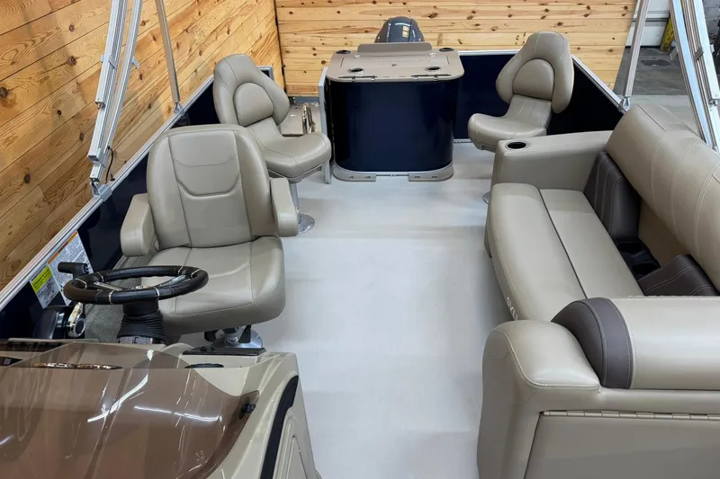 Slide: The Image of 2024 Sylvan Party Fish 820 pontoon boat interior with beige seating and wooden accents. - 7