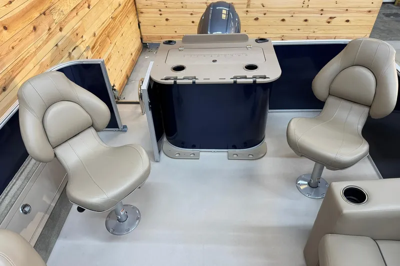 Slide: The Image of 2024 Sylvan Party Fish 820 interior with beige seats and wooden paneling. - 8