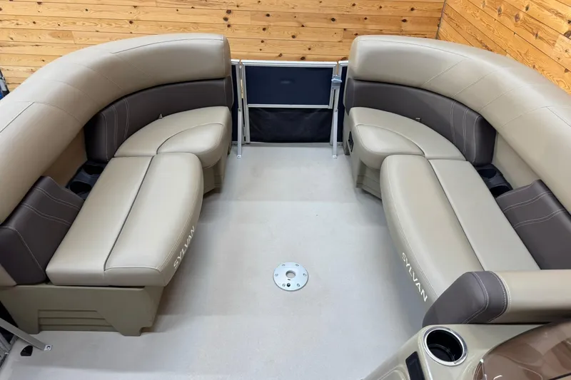 Slide: The Image of 2024 Sylvan Party Fish 820 boat interior with beige and brown seating. - 9