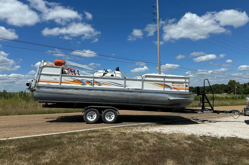 Slide: The Image of 2007 PlayCraft 22 Clipper pontoon boat on trailer under blue sky. - 1