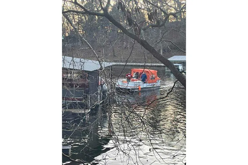 Slide: The Image of 2007 PlayCraft 22 Clipper boat with orange canopy on a calm lake near docks. - 3