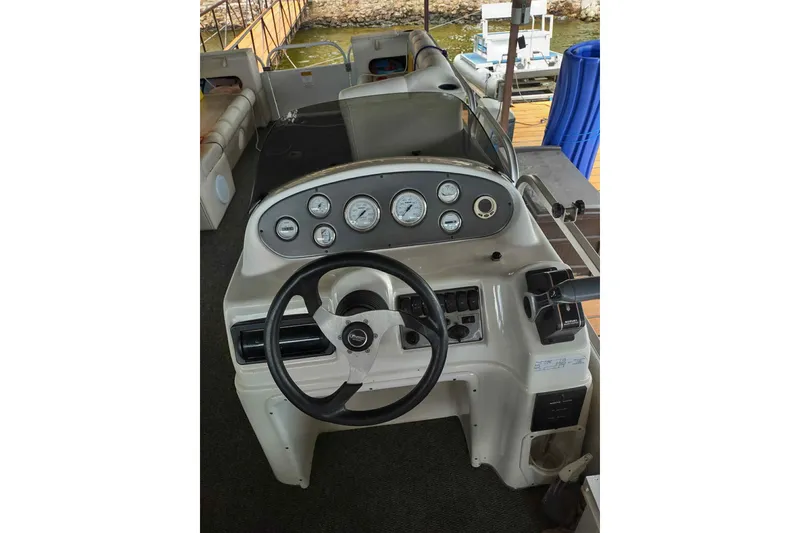 Slide: The Image of 2007 PlayCraft 22 Clipper boat dashboard with steering wheel and gauges. - 7