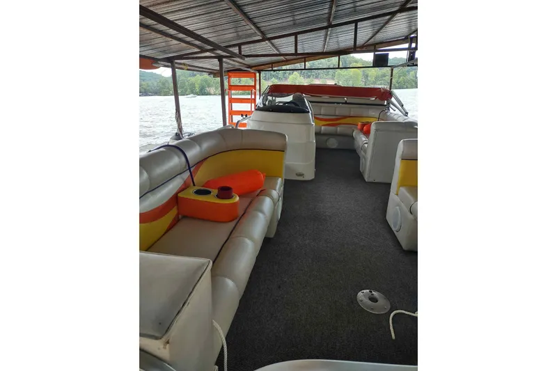 Slide: The Image of 2007 PlayCraft 22 Clipper boat interior with cushioned seating and lake view. - 8