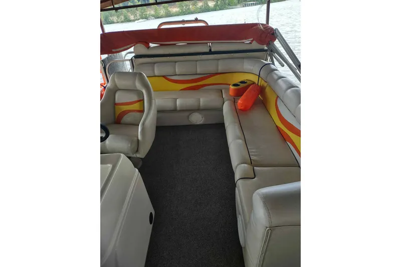 Slide: The Image of 2007 PlayCraft 22 Clipper boat interior with cushioned seating and vibrant orange accents. - 9