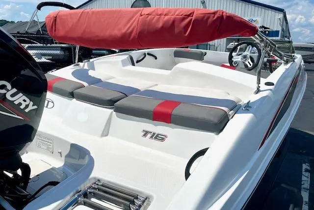 Slide: The Image of 2022 Tahoe T6 boat with red canopy and Mercury engine, docked outdoors. - 5