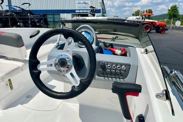 Slide: The Image of 2022 Tahoe T6 boat dashboard with steering wheel and control panel. - 6