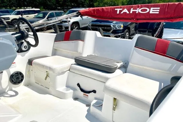 Slide: The Image of 2022 Tahoe T6 boat interior with seating, steering wheel, and red accents. - 8