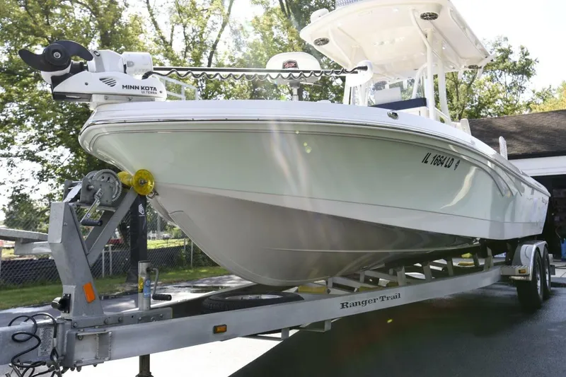 Slide: The Image of 2022 Ranger 2360 Bay boat on trailer, featuring Minn Kota motor, parked outdoors. - 18