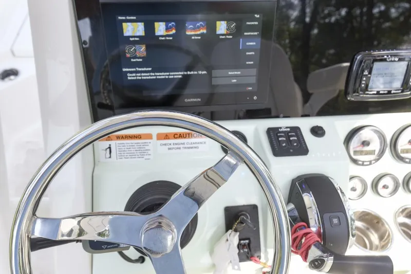 Slide: The Image of 2022 Ranger 2360 Bay boat dashboard with steering wheel and electronic controls. - 27
