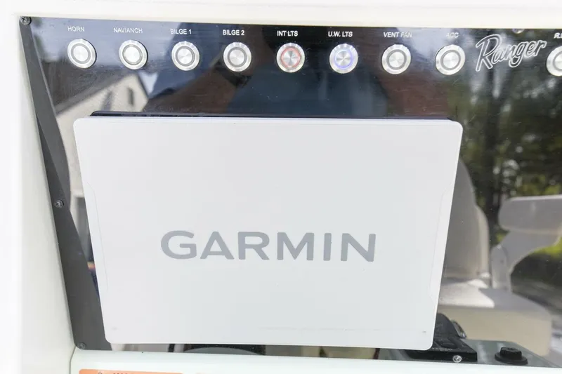 Slide: The Image of Control panel of 2022 Ranger 2360 Bay boat with Garmin display and various switches. - 29