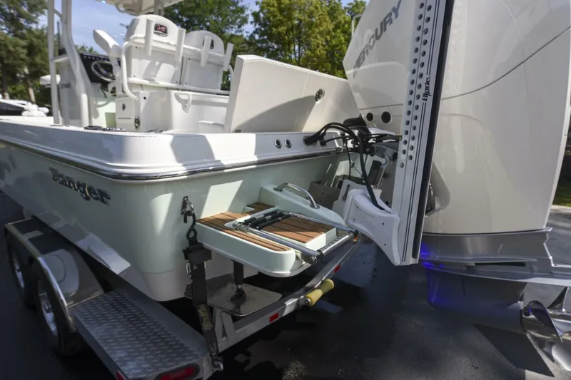 Slide: The Image of 2022 Ranger 2360 Bay boat with Mercury engine, featuring a rear deck and ladder. - 38
