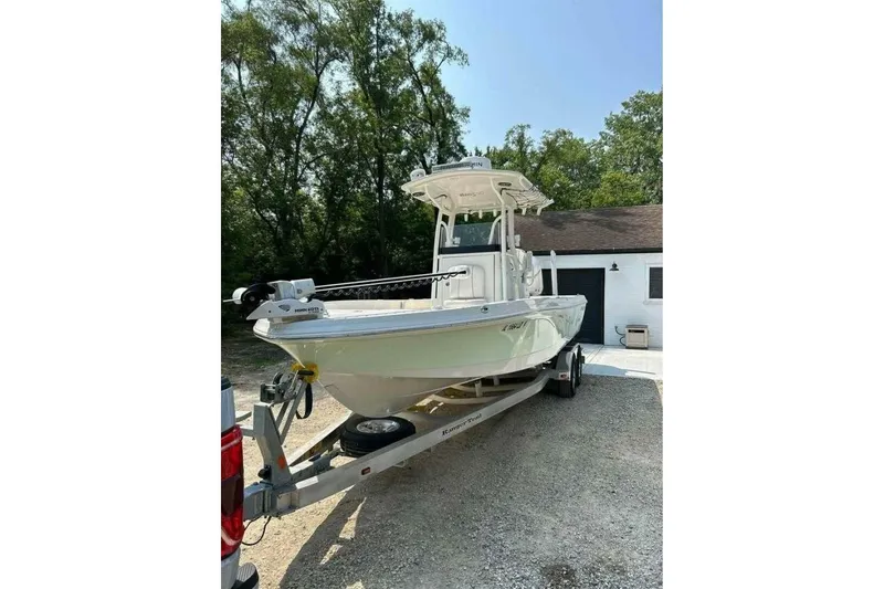 Slide: The Image of 2022 Ranger 2360 Bay boat on trailer, top view, white exterior, Mercury engine. - 4