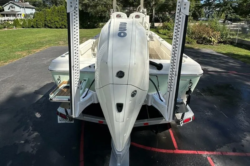 Slide: The Image of 2022 Ranger 2360 Bay boat with outboard motor on trailer, parked on driveway. - 48