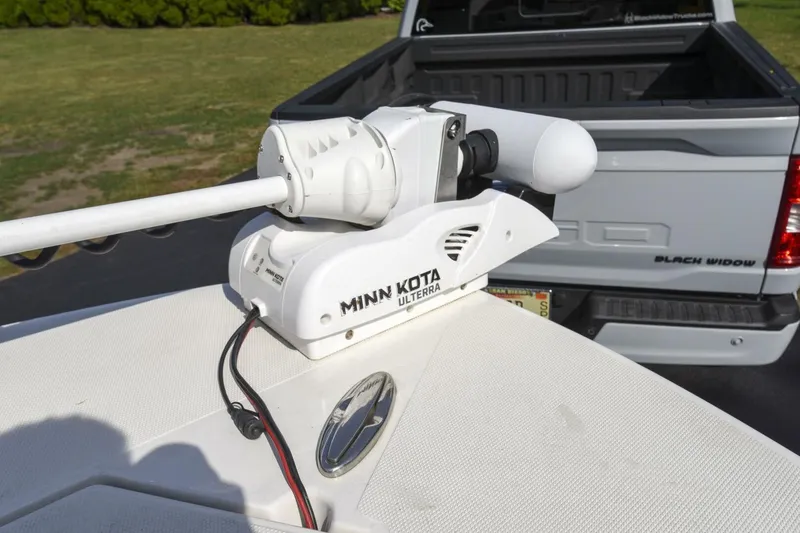 Slide: The Image of Minn Kota Ulterra trolling motor on 2022 Ranger 2360 Bay boat, parked near a truck. - 51
