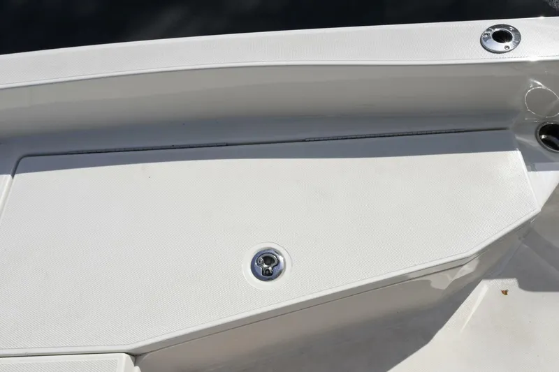 Slide: The Image of 2022 Ranger 2360 Bay boat deck with storage compartment and cup holder. - 53