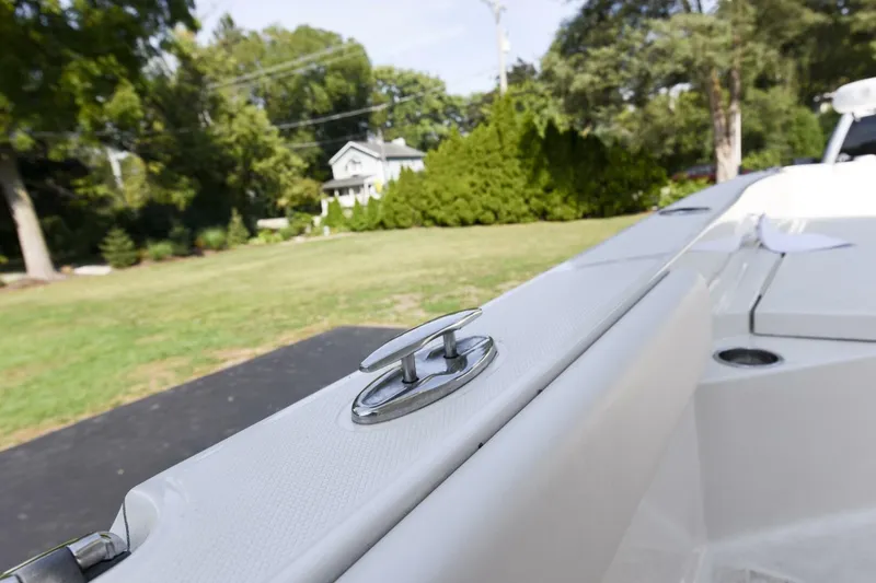 Slide: The Image of 2022 Ranger 2360 Bay boat detail with cleat, parked in a residential area. - 60