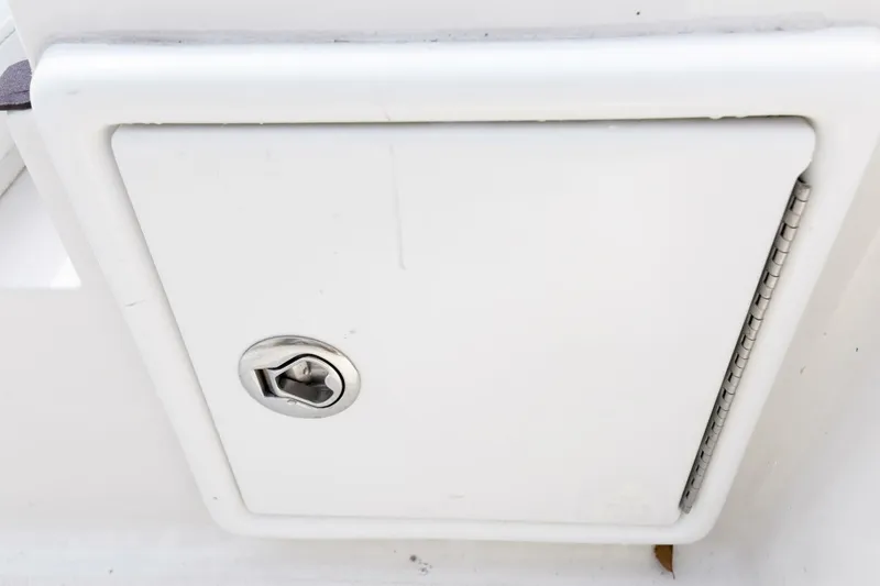 Slide: The Image of White storage compartment on 2022 Ranger 2360 Bay boat with metal latch. - 68