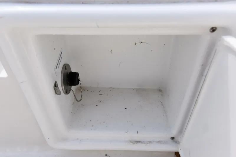 Slide: The Image of 2022 Ranger 2360 Bay storage compartment with plug and chain. - 69