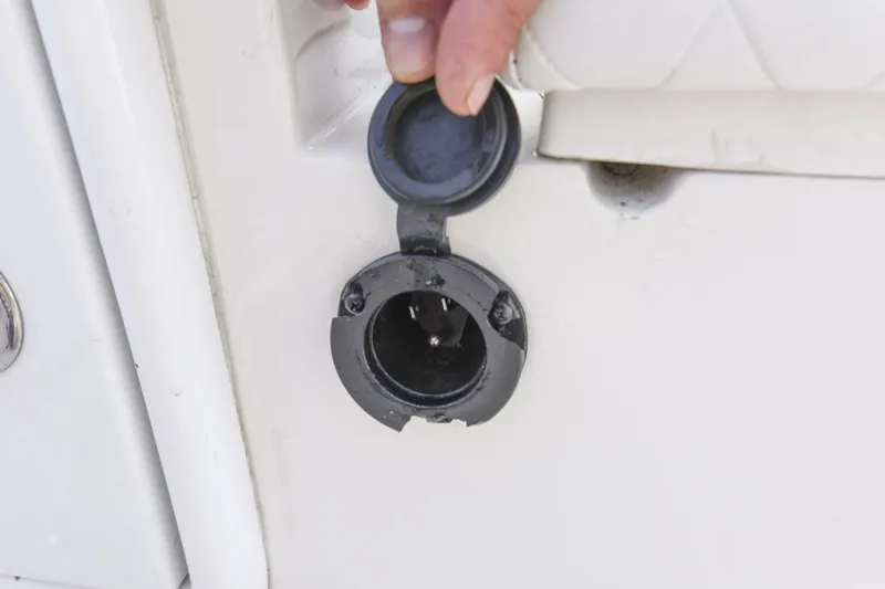 Slide: The Image of 2022 Ranger 2360 Bay boat power outlet with cover open. - 72