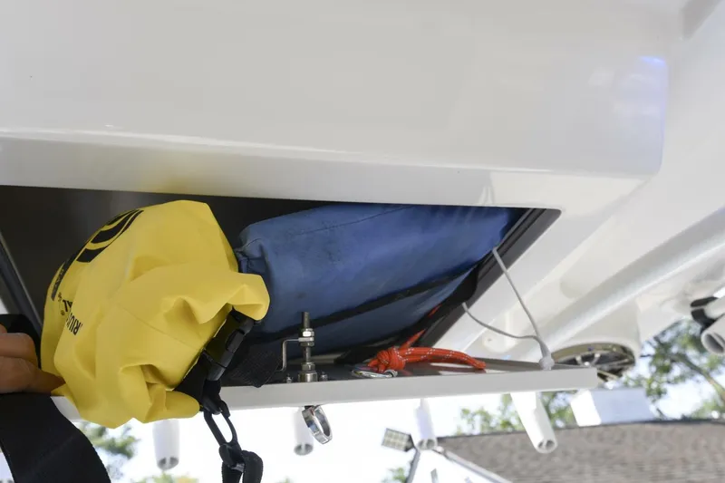 Slide: The Image of Storage compartment on 2022 Ranger 2360 Bay boat with safety gear and equipment. - 75
