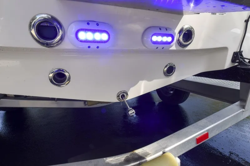 Slide: The Image of 2022 Ranger 2360 Bay boat with illuminated blue LED lights on the rear. - 80
