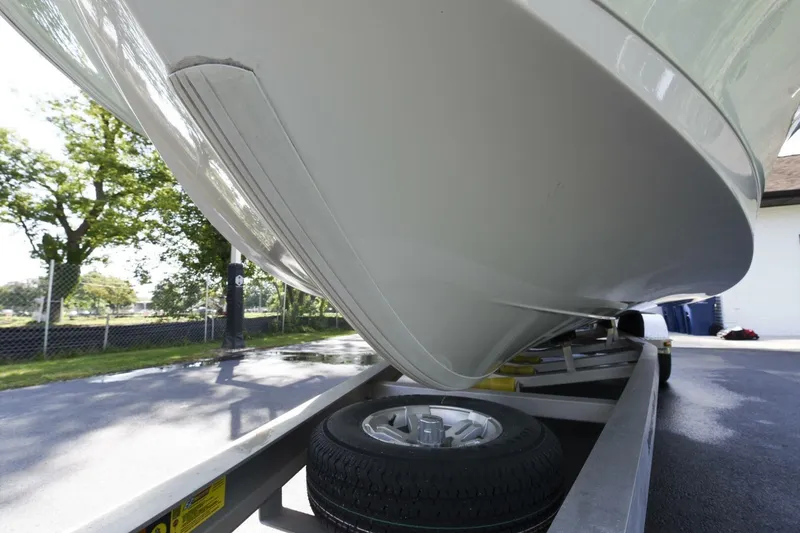Slide: The Image of 2022 Ranger 2360 Bay boat on trailer, close-up view of hull and wheel. - 82