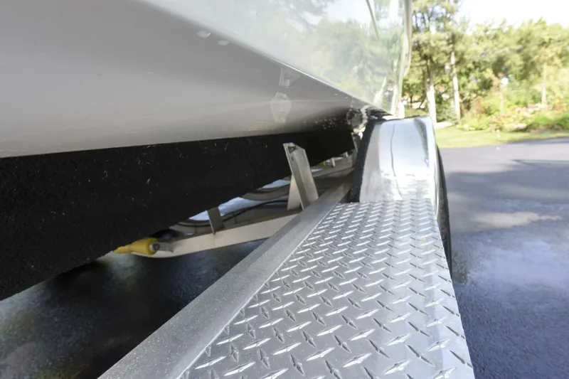 Slide: The Image of 2022 Ranger 2360 Bay boat on trailer, close-up of hull and diamond plate fender. - 84