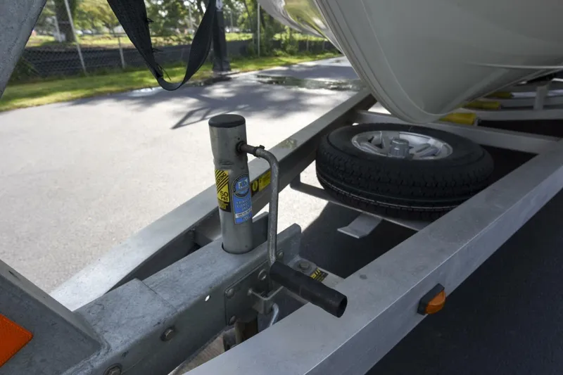 Slide: The Image of Trailer hitch and spare tire for 2022 Ranger 2360 Bay boat on pavement. - 90