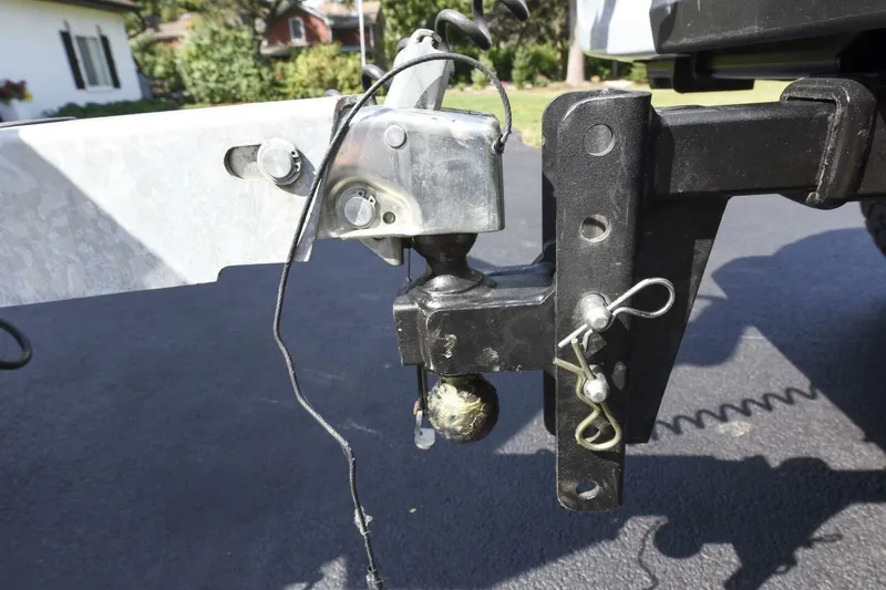 Slide: The Image of Trailer hitch connection on a 2022 Ranger 2360 Bay, parked on a driveway. - 91