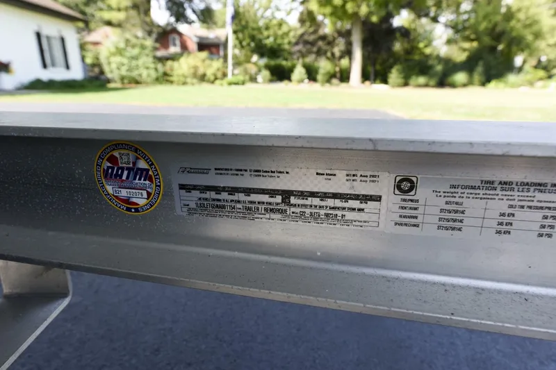 Slide: The Image of Label on a 2022 Ranger 2360 Bay trailer, showing compliance and tire information. - 94