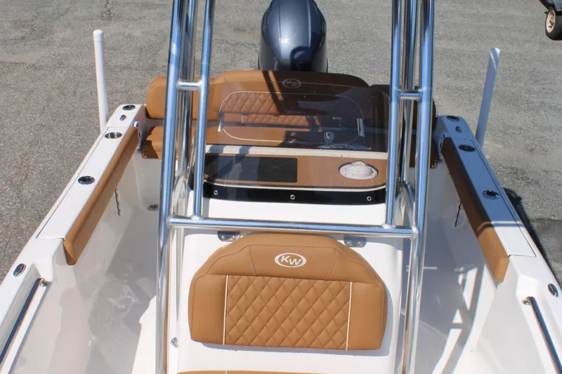 Slide: The Image of 2026 Key West 189 FS boat interior with tan seating and sleek console design. - 17