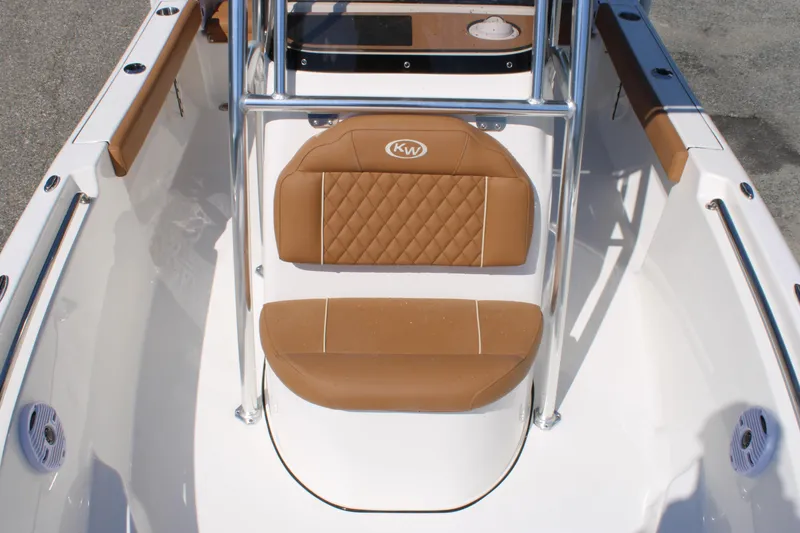 Slide: The Image of 2026 Key West 189 FS boat interior with tan cushioned seating and stainless steel frame. - 18