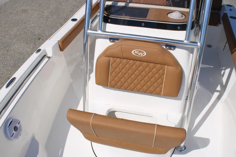 Slide: The Image of 2026 Key West 189 FS boat interior with tan cushioned seating and stainless steel frame. - 19