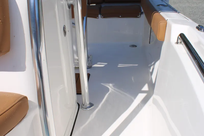 Slide: The Image of 2026 Key West 189 FS boat interior with tan seating and stainless steel railings. - 21