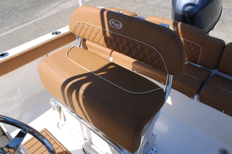 Slide: The Image of 2026 Key West 189 FS boat with tan cushioned seating and stainless steel accents. - 22