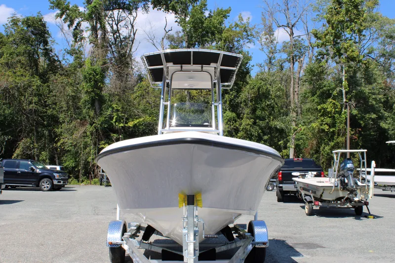 Slide: The Image of Front view of 2026 Key West 189 FS boat on trailer, surrounded by trees. - 9