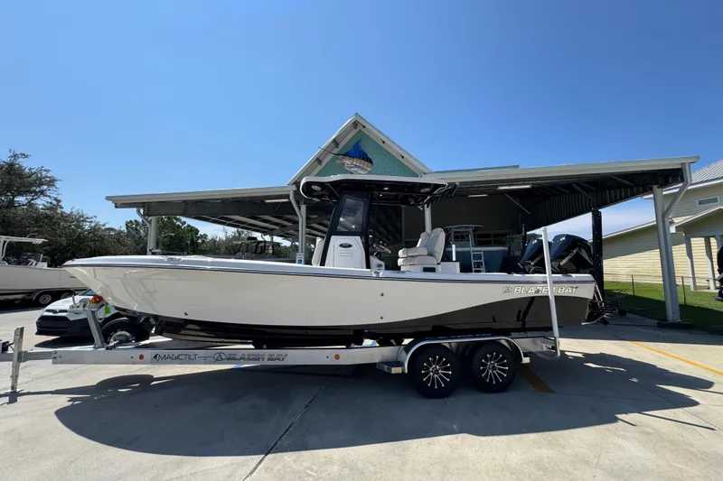 The Image of 2026 Blazer 2800 Makaira boat on trailer, parked outdoors under clear sky. - 1