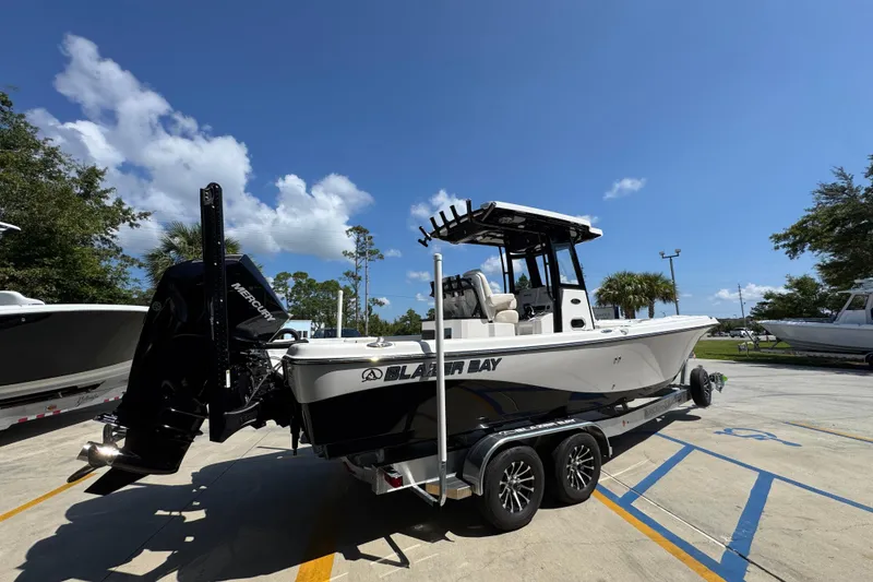 Slide: The Image of 2026 Blazer 2800 Makaira boat on trailer under clear blue sky. - 11