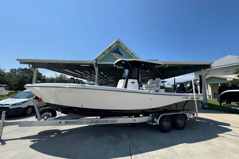 Slide: The Image of 2026 Blazer 2800 Makaira boat on trailer under sunny sky. - 2