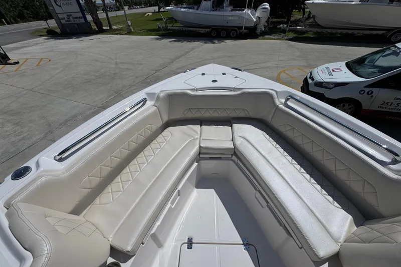 Slide: The Image of 2026 Blazer 2800 Makaira boat with spacious, cushioned seating in a marina setting. - 20