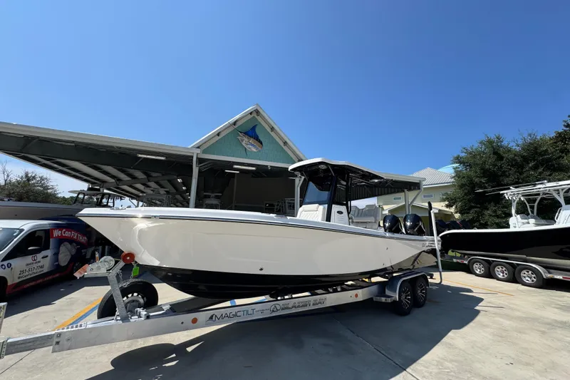 Slide: The Image of 2026 Blazer 2800 Makaira boat on trailer, parked outside a marine facility. - 3