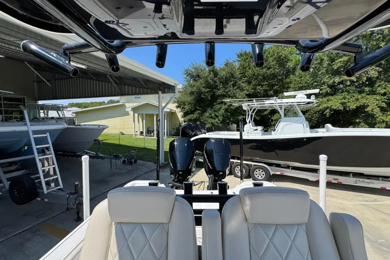 Slide: The Image of 2026 Blazer 2800 Makaira boat with dual engines in a marina setting. - 31